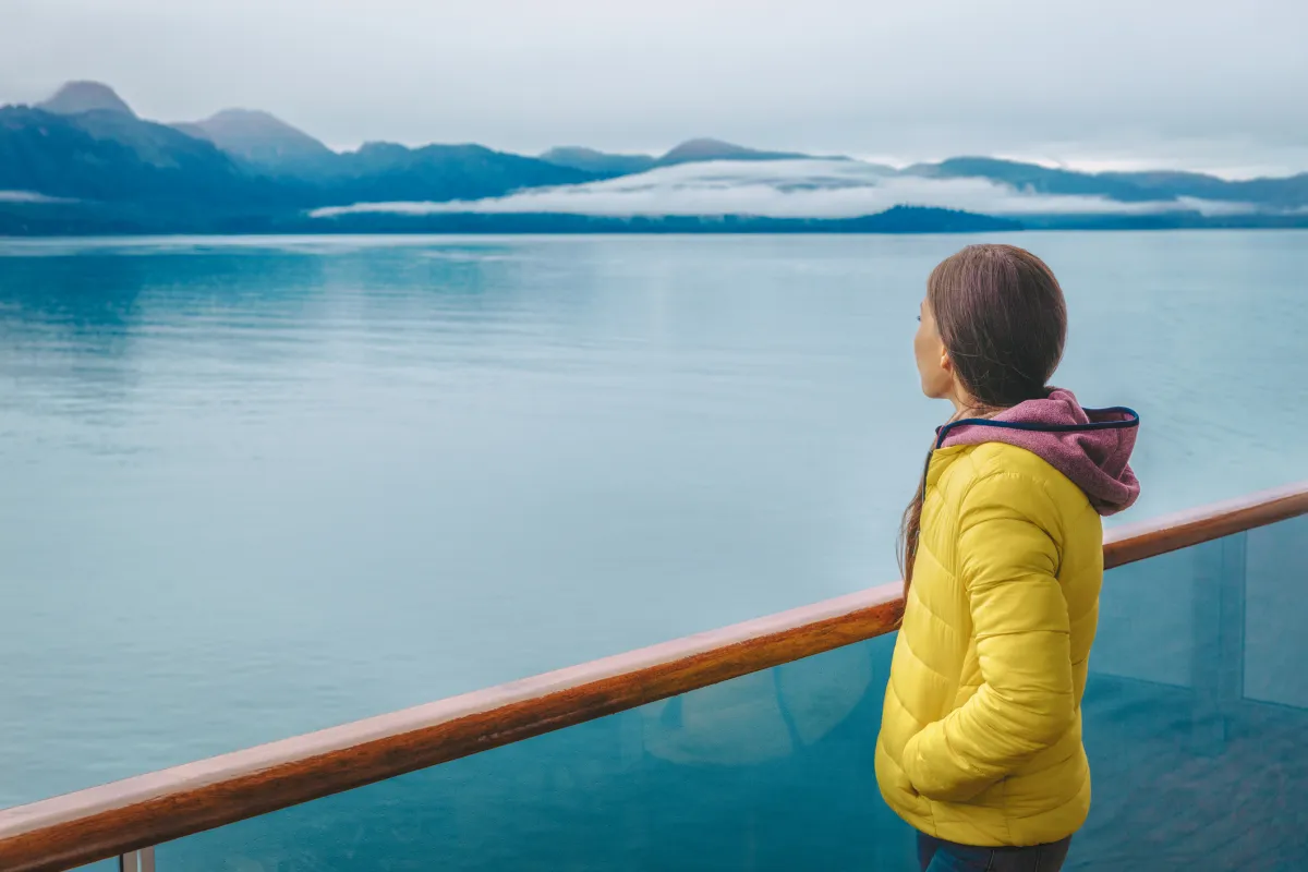 tourist looking at mountains landscape from balcony